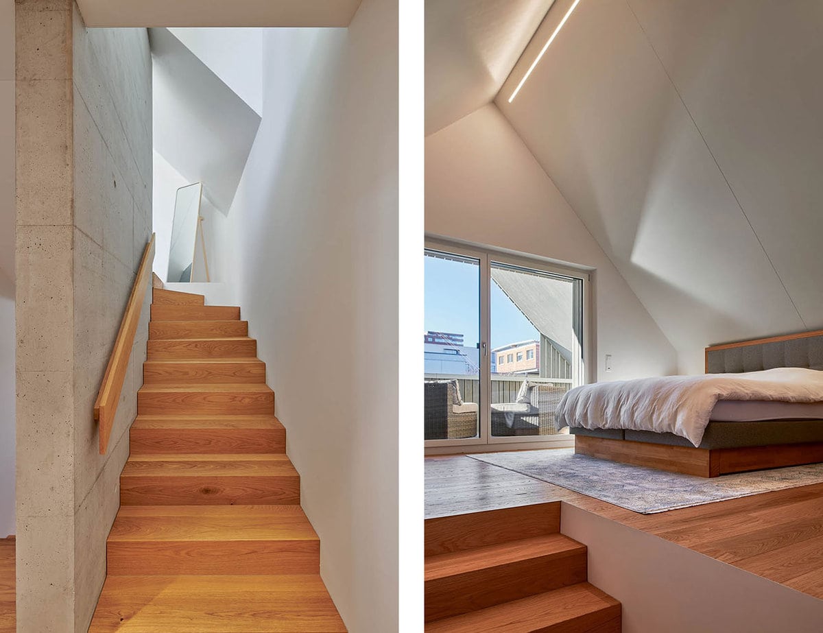 Treppe in den zweiten Stock. Die Treppe ist aus Holz, die Wände an beiden Seite der Treppe aus Beton. Die Treppe führt ins Schlafzimmer, welches dieselben Materialen verwendet.